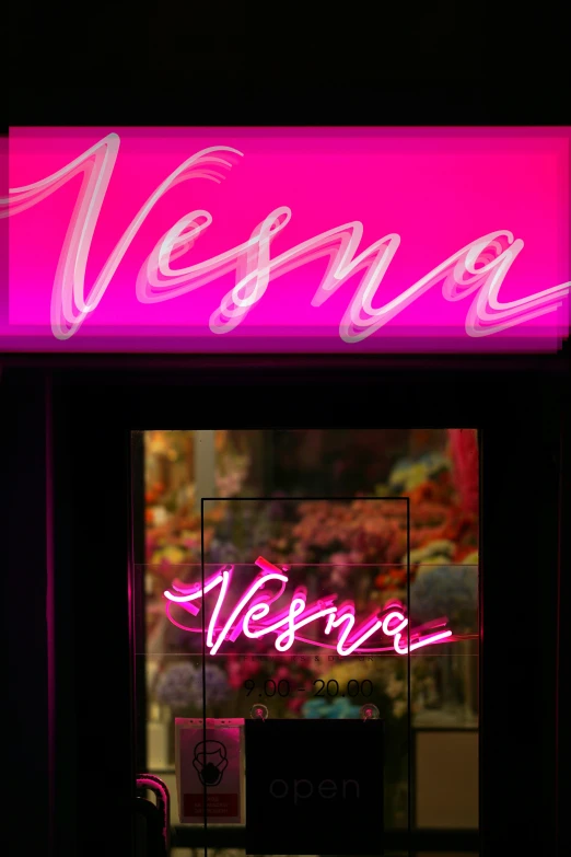 a neon sign sitting on top of a black door