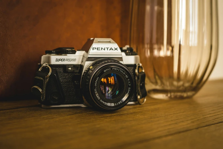 a black camera sitting on top of a wooden table