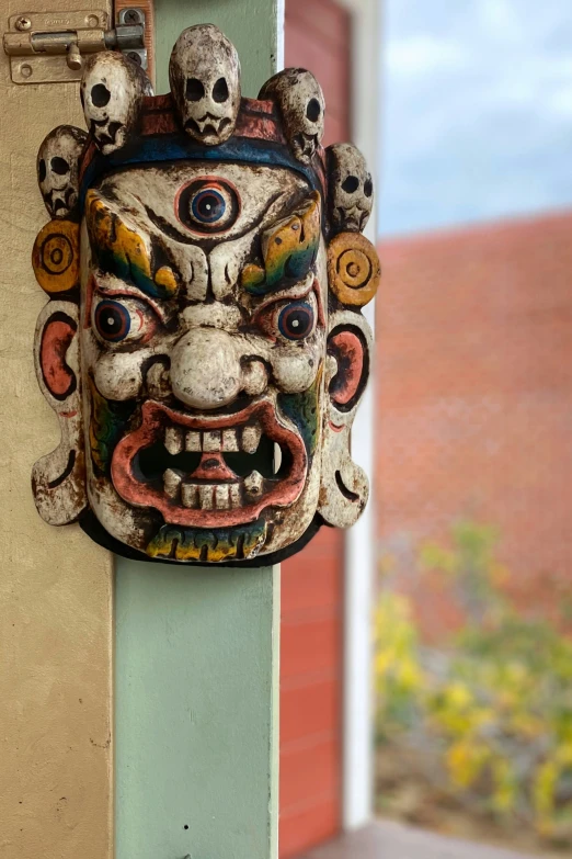 the head of a statue has eyes and long tongues