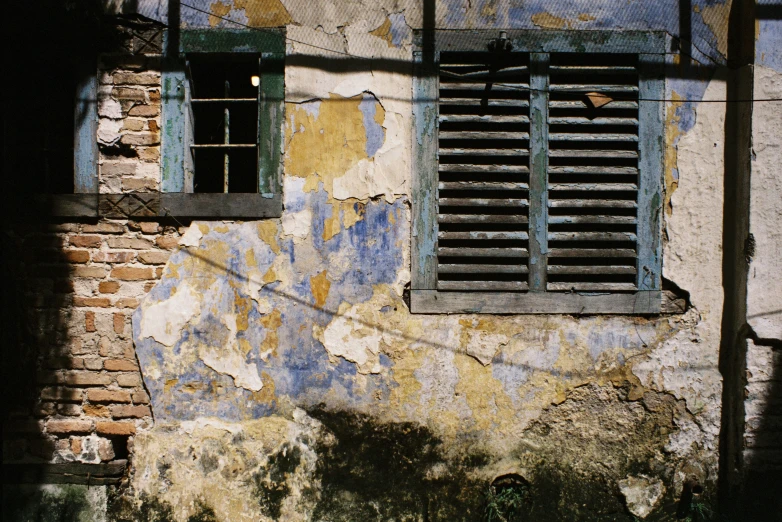 a broken down wall with some windows on it