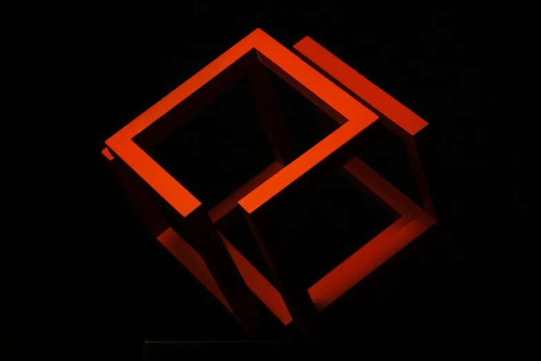 an artistic, red sculpture is shown in the dark