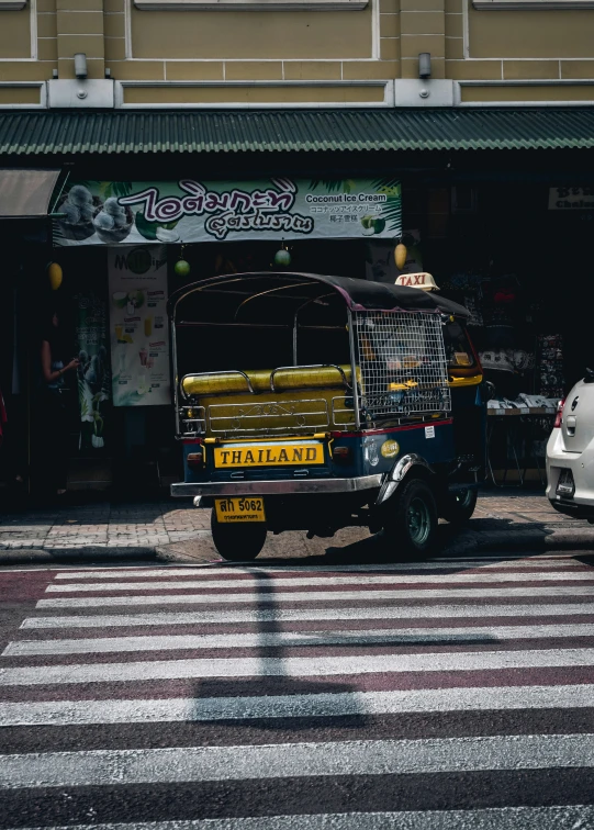 a truck with its cage on it parked by a building