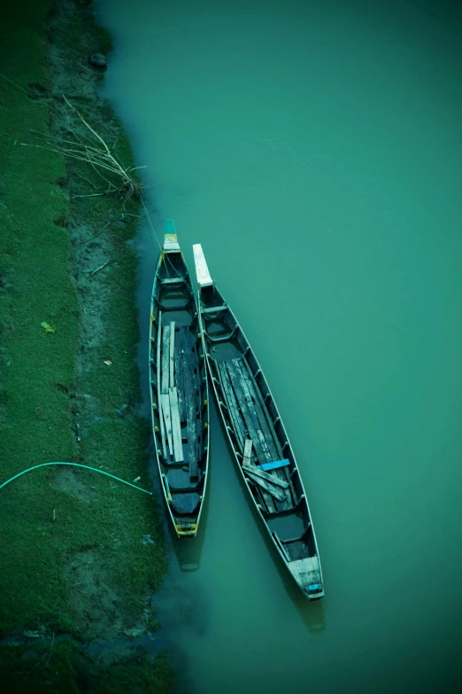 two small boats float near the shore