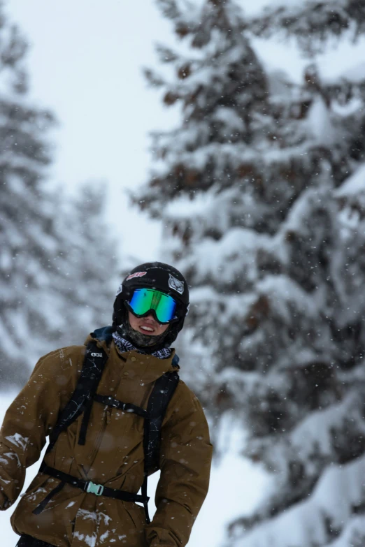 a man is walking on the snowboard with some skis