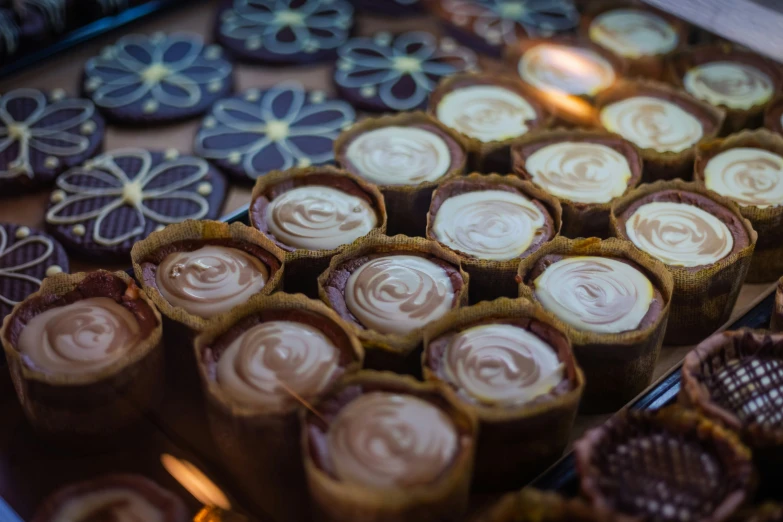 some chocolate cups that have some icing on them