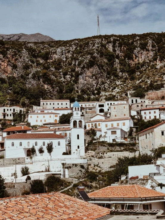 a scenic town has tall buildings and a hillside