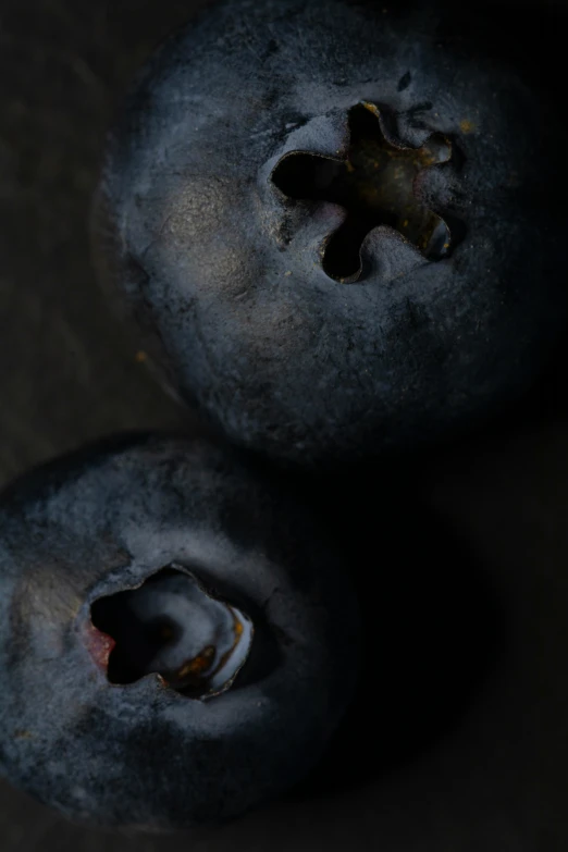 two blueberries that have been bitten open