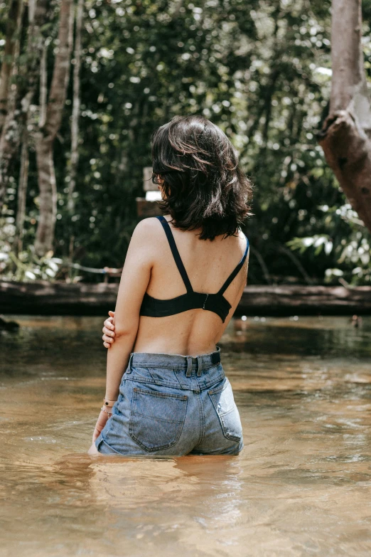 a woman is standing in a shallow water pool