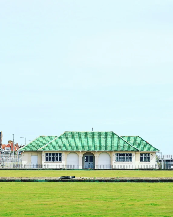 a building with a green roof on top