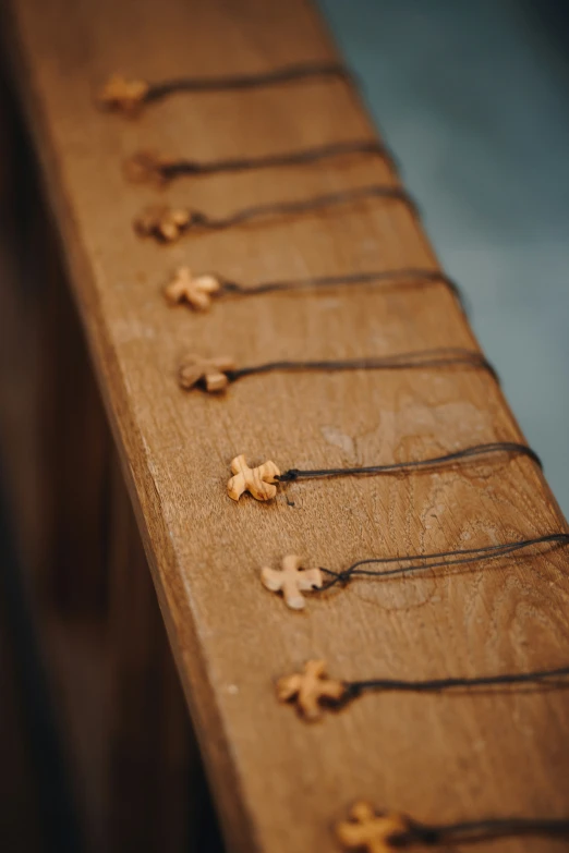 small crosses are placed on a wood bench