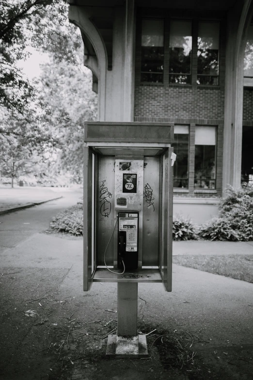 an old - fashioned pay phone in front of a building
