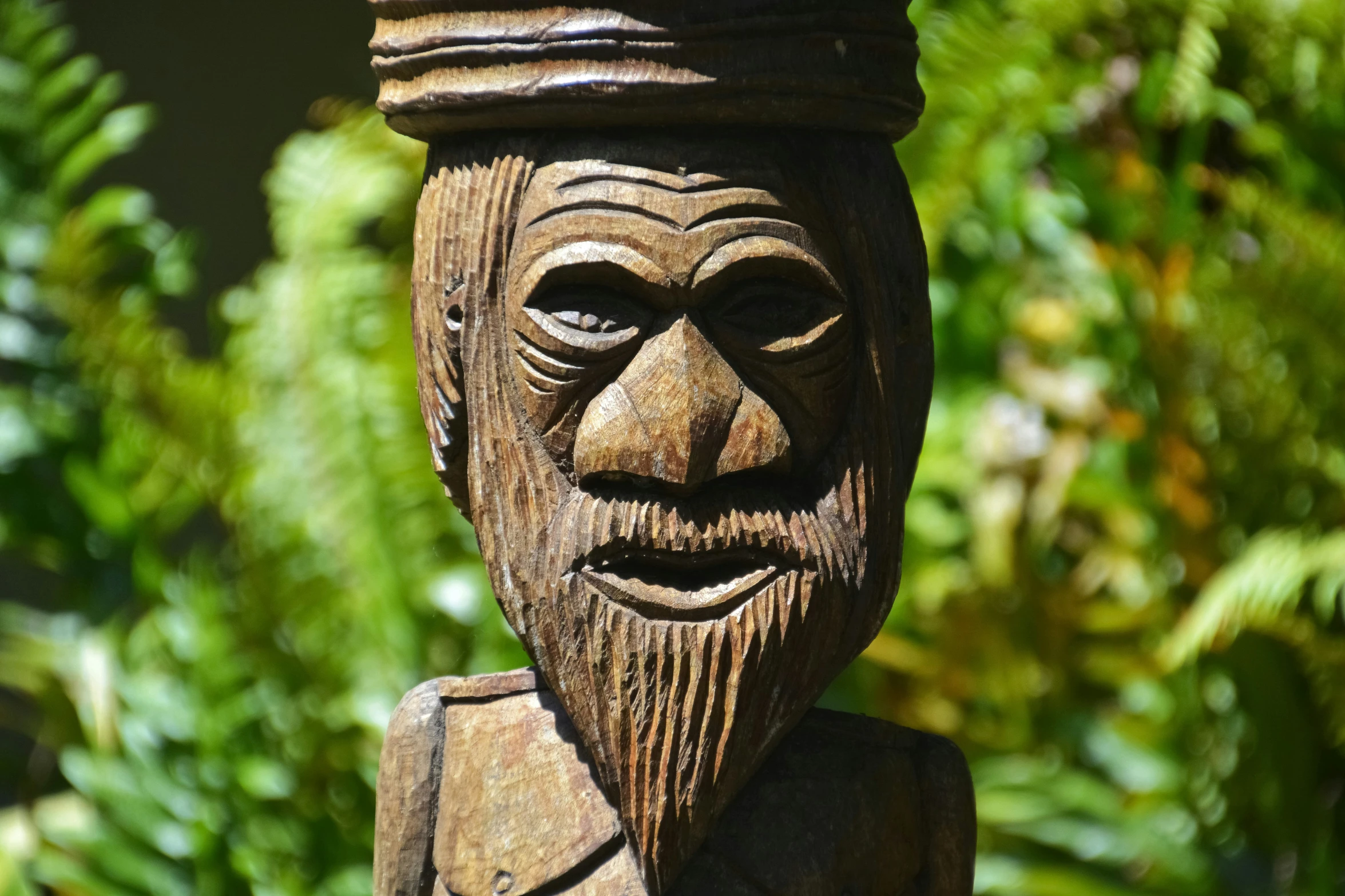 wooden carving of an old man with a crown