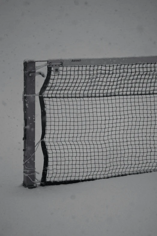 the back of a ball racket sitting in the snow