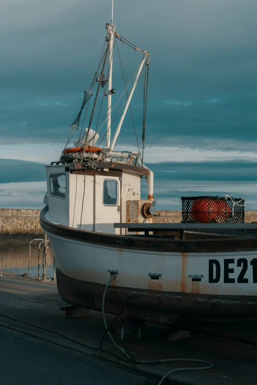 a white boat sitting next to a metal ramp