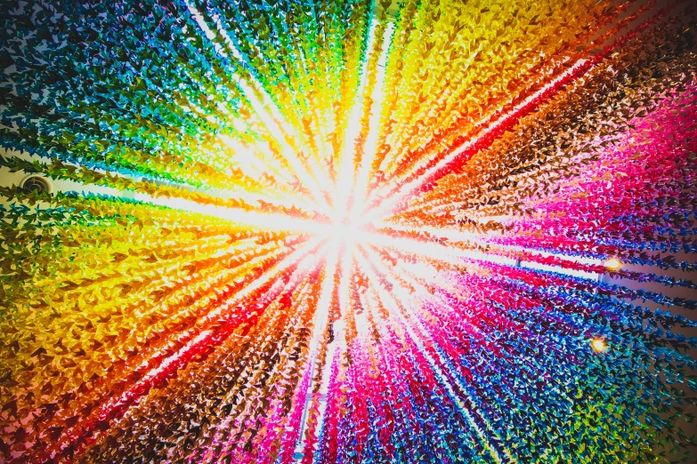 the top view of multicolored rays coming out of a starburst