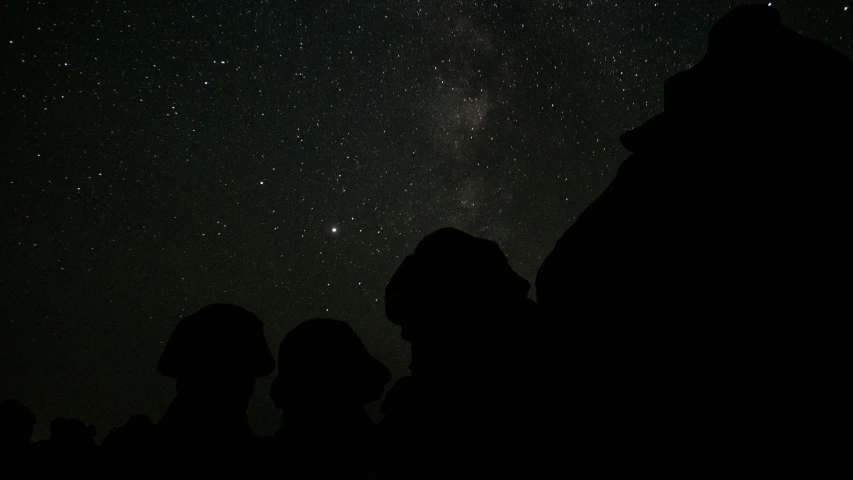 some rocks and some stars in the night sky