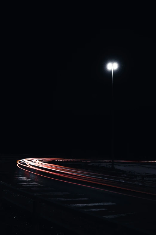 traffic lights and cars going past in the dark