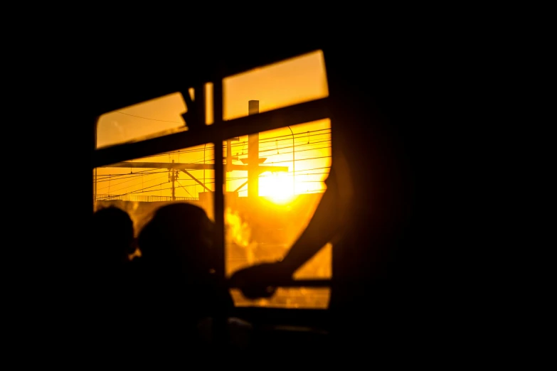 a close up of two people near an open window