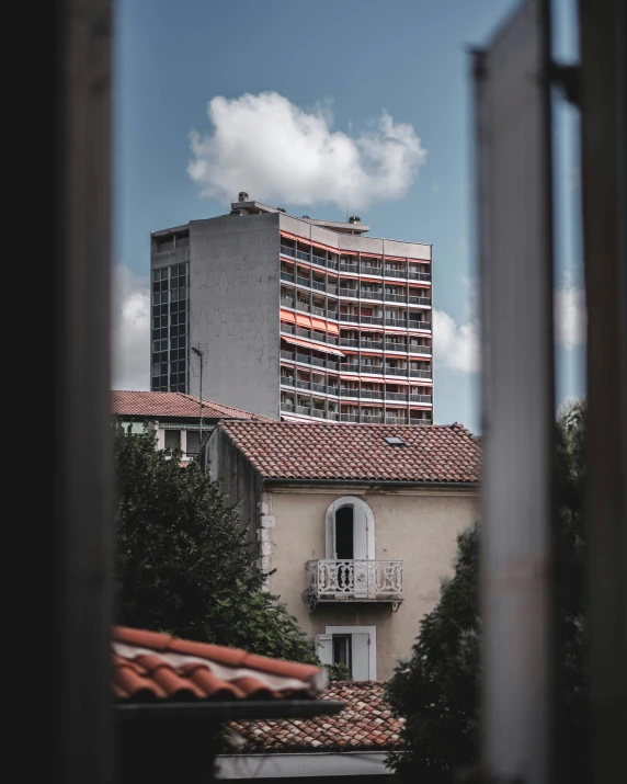 the top of a building from the outside with a window