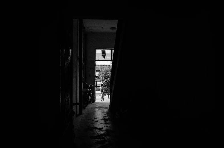 black and white po of an open door leading to an apartment