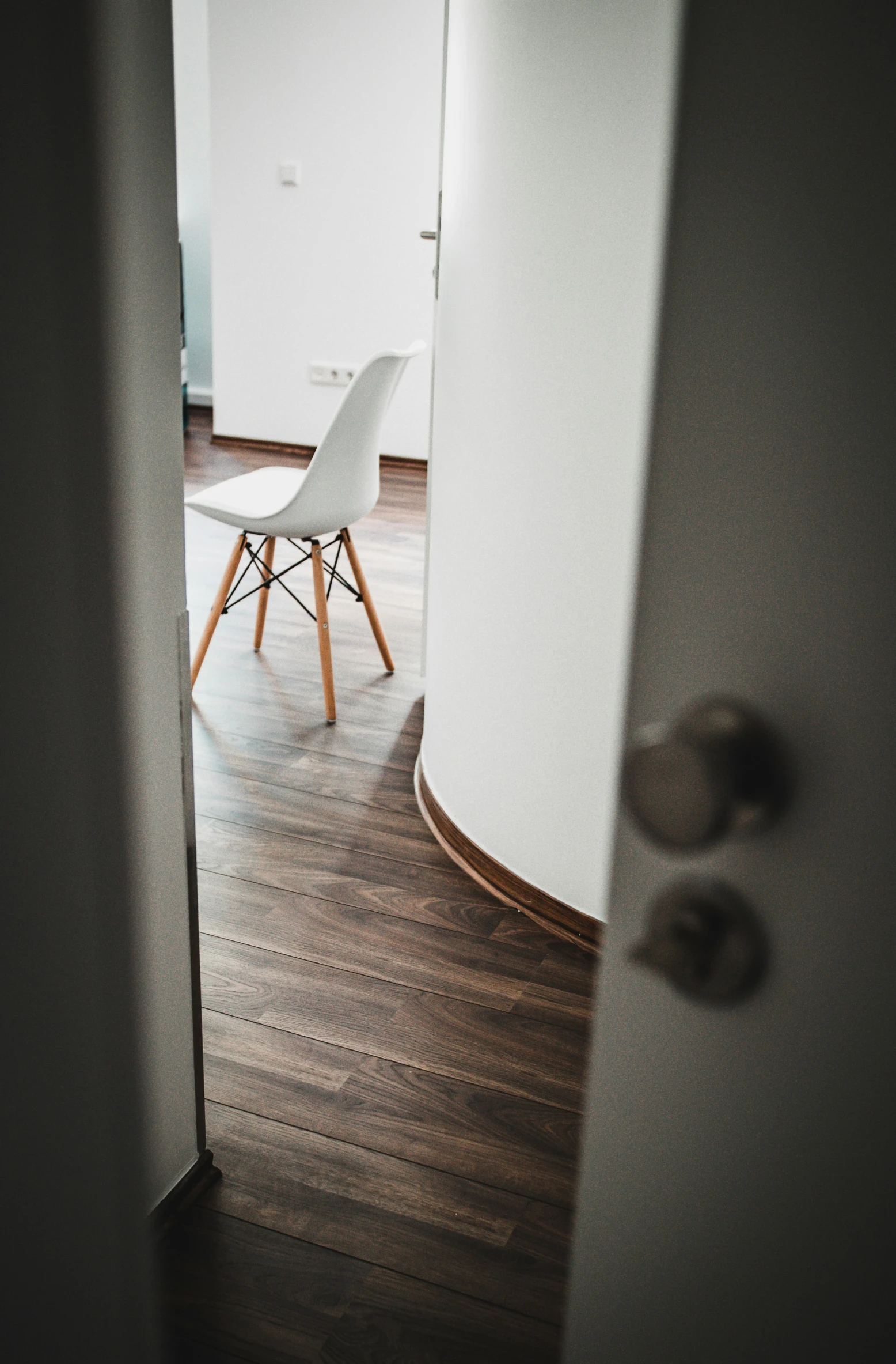 a chair is sitting at a table near a white wall