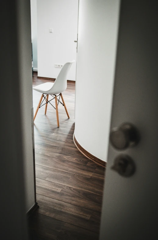 a chair is sitting at a table near a white wall