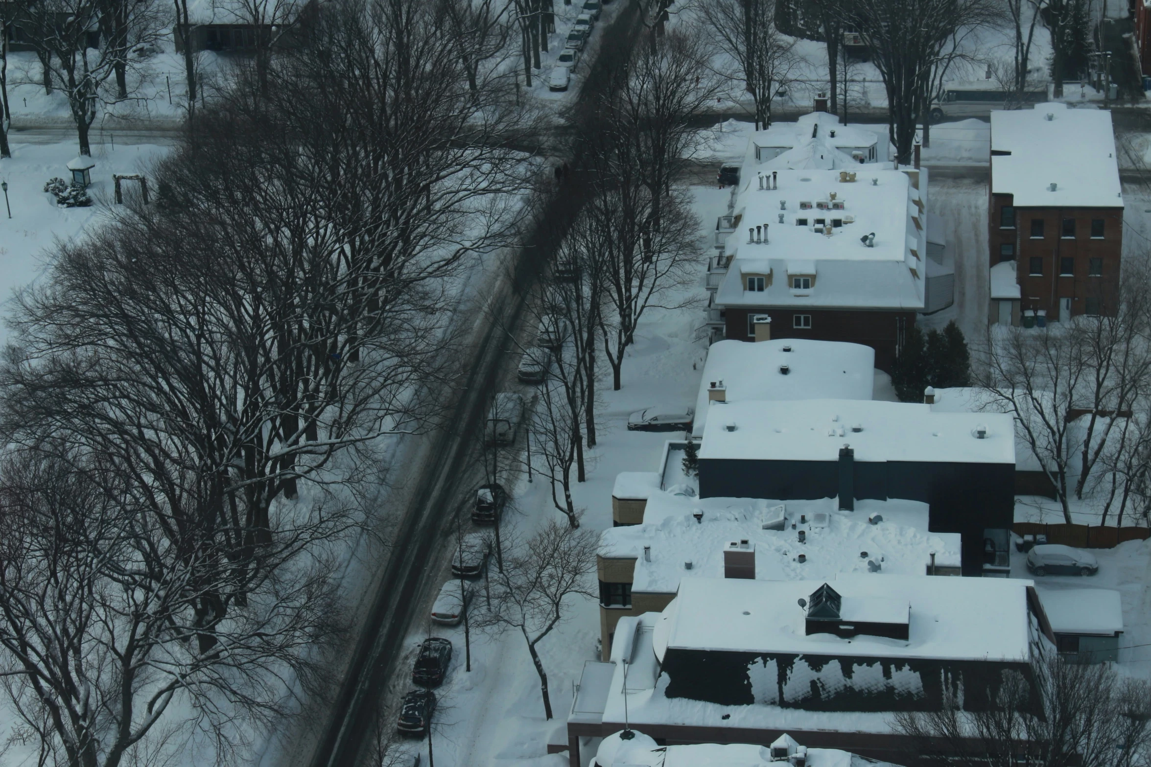 aerial view of a town with houses, buildings, and snow