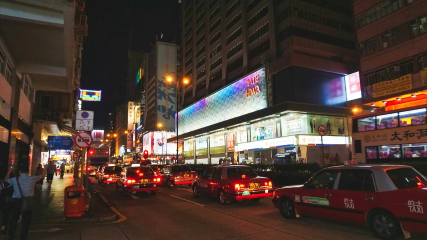 many cars on a city street with buildings in the background