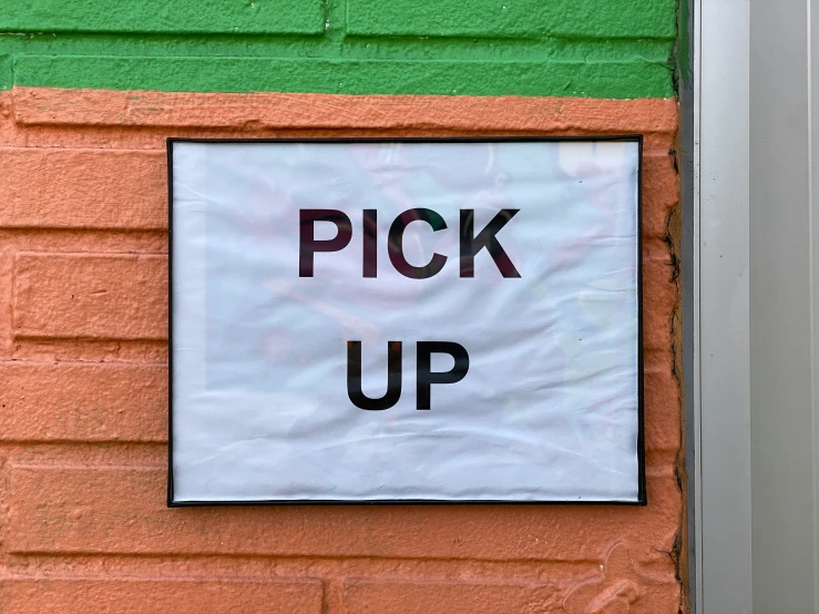 a sign in a door says pick up