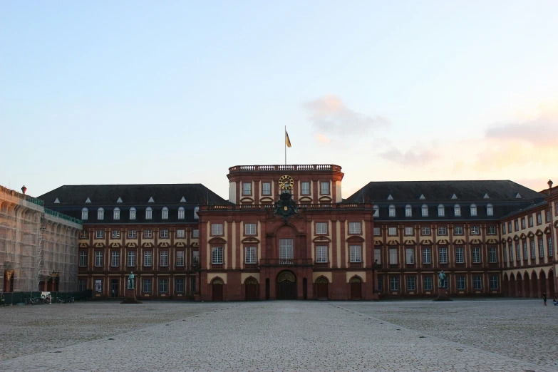 an old building with some buildings and some flags