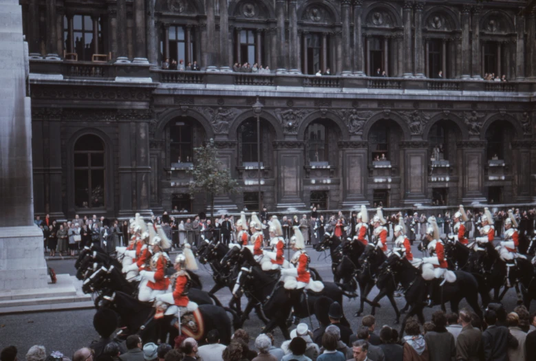 a large group of people riding horses in the street