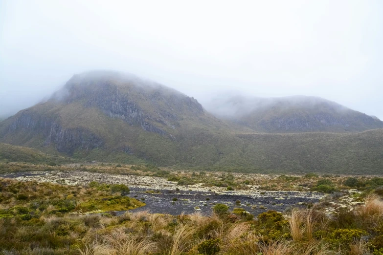 the hills and the river are covered by mist