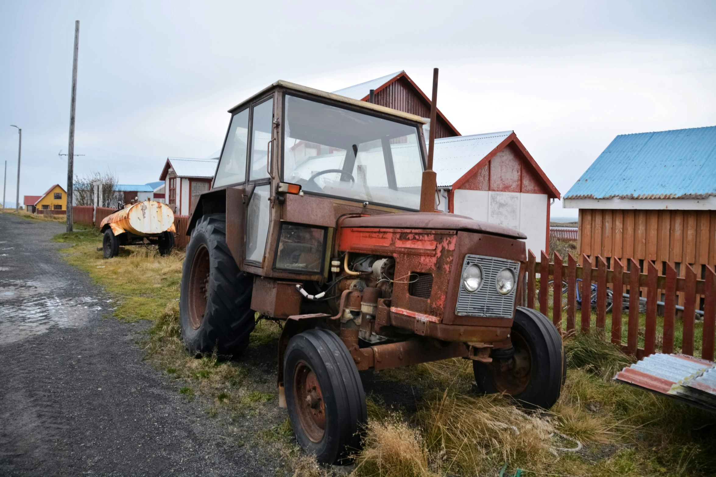 an old tractor is shown sitting in the grass