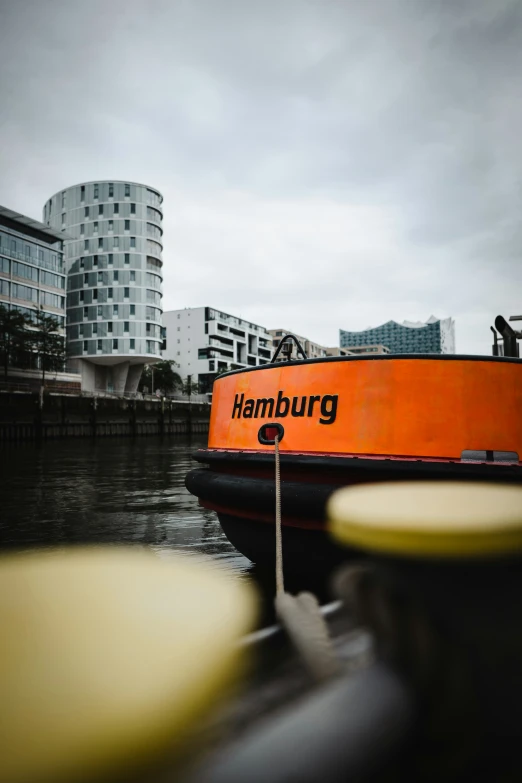 a boat sitting in the water with an orange sign on it