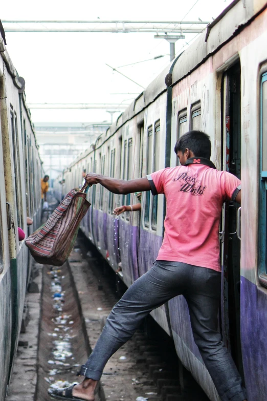 man in a red shirt is trying to get out of the train