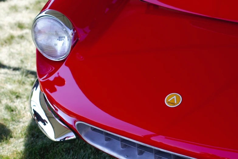 the back end of a red car with an emblem