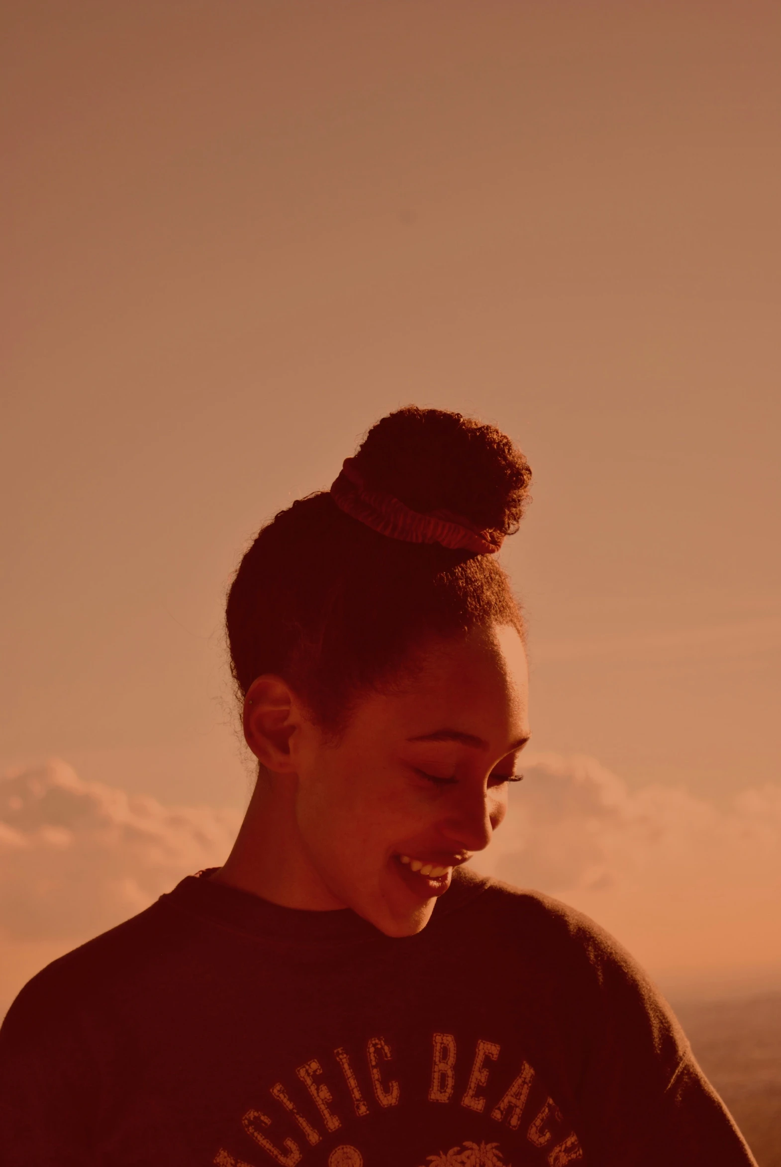 a woman smiles and puts her hands up near her chest