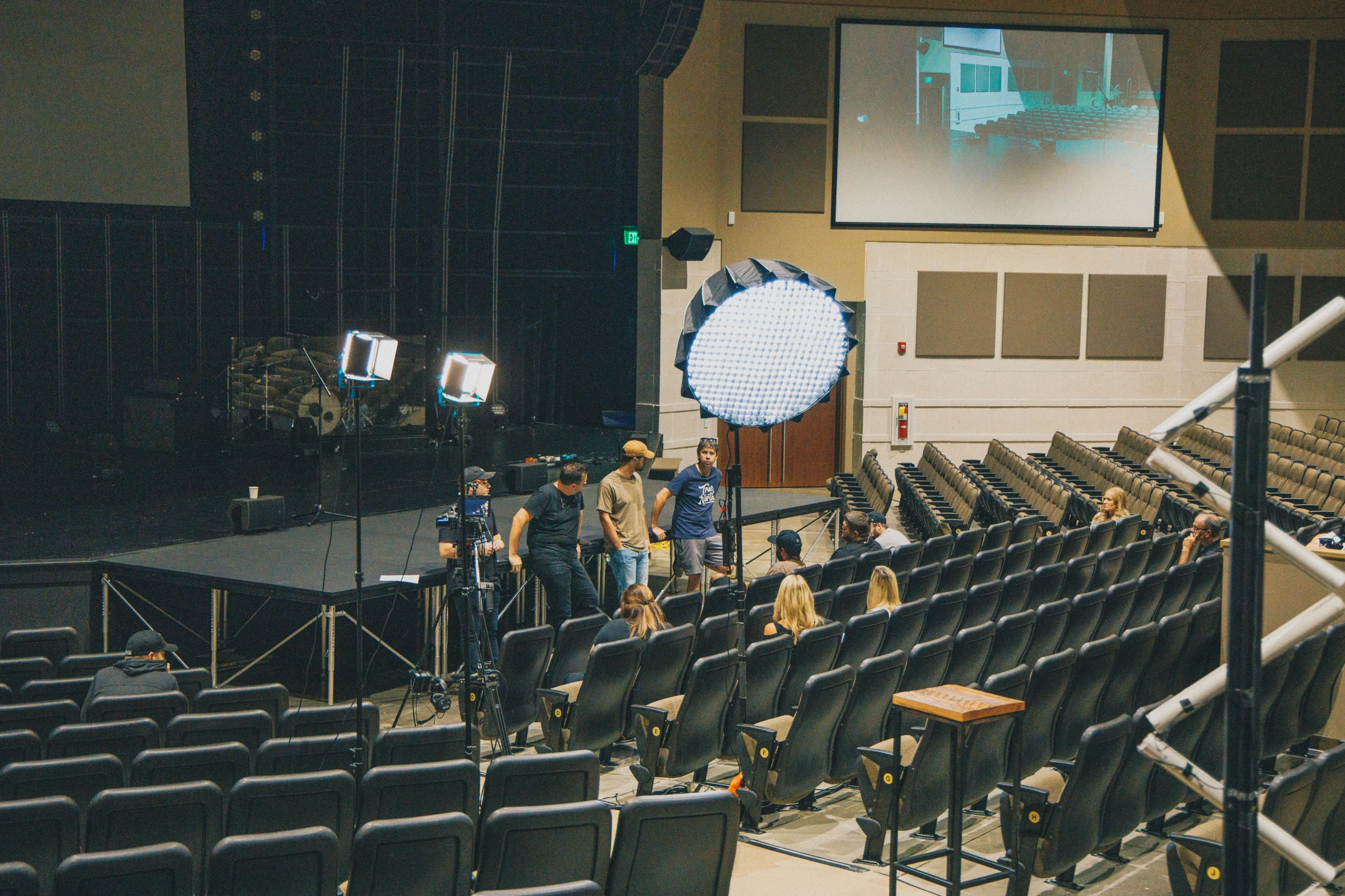 the audience is watching the screen at a concert