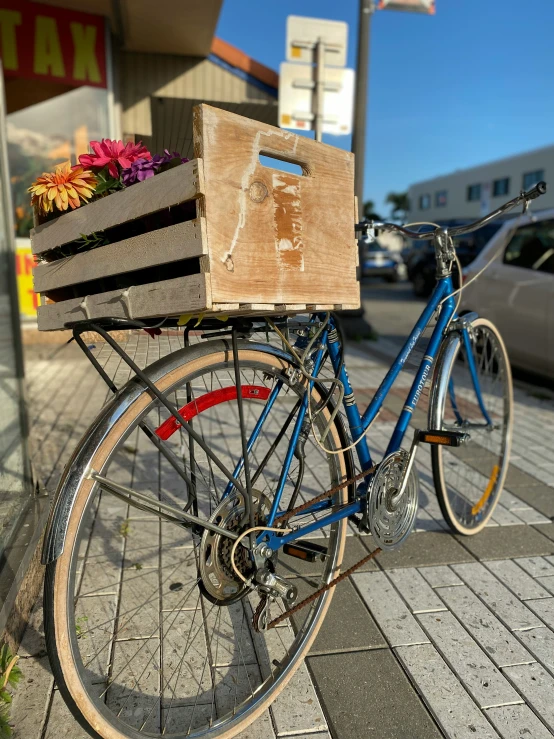 a bike parked next to the curb with flower boxes on it