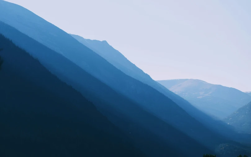 a hill view with mountains in the distance