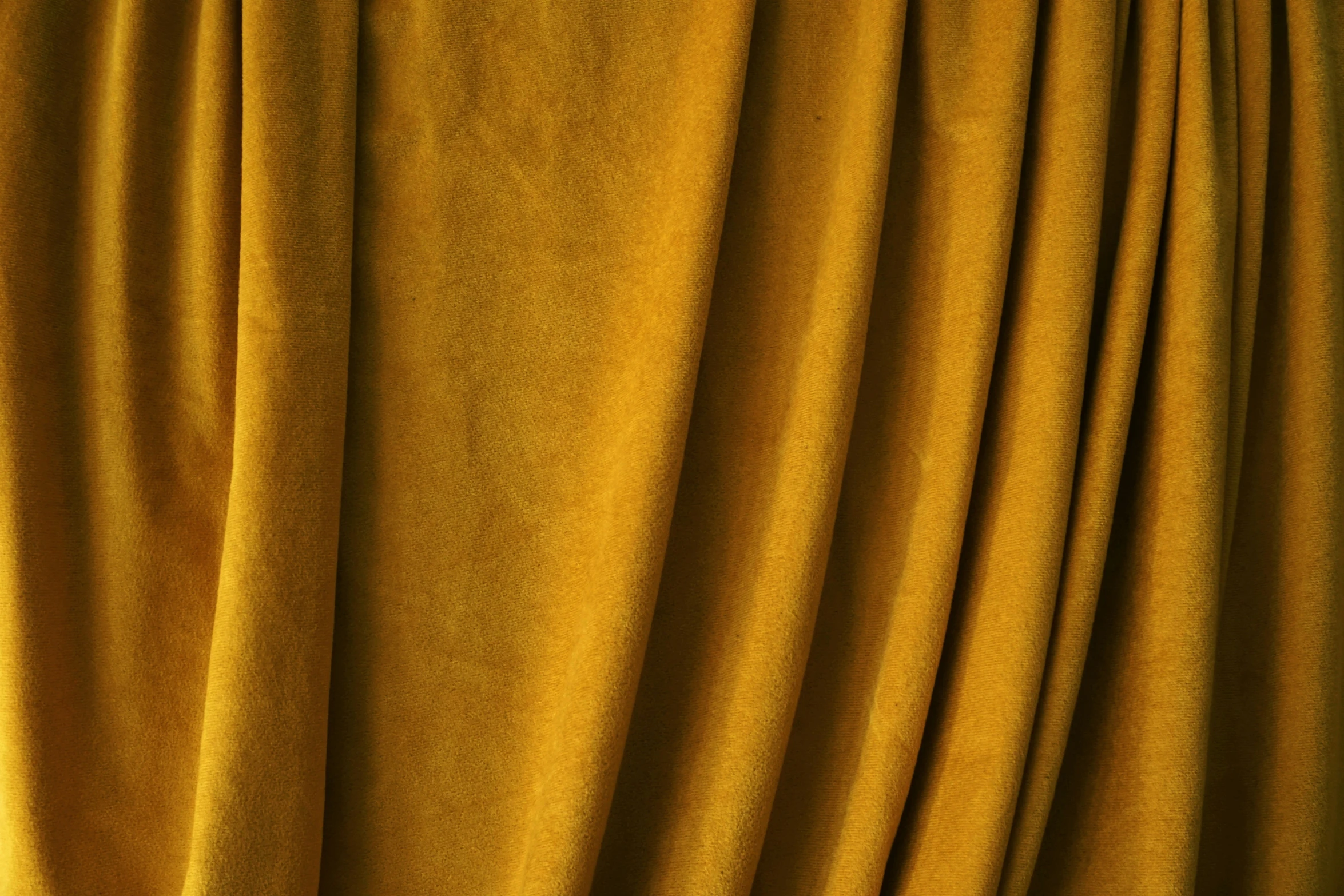 a curtain with yellow fabric and orange tie dye