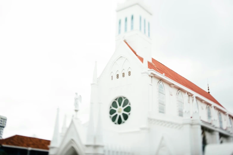 the front of the building has a tall bell tower