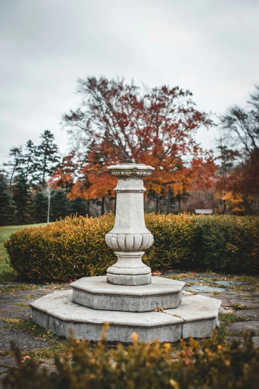 there is an empty pillar in the middle of a park