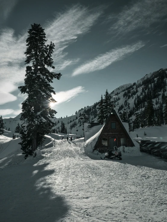 the sun sets over a cabin in the mountains