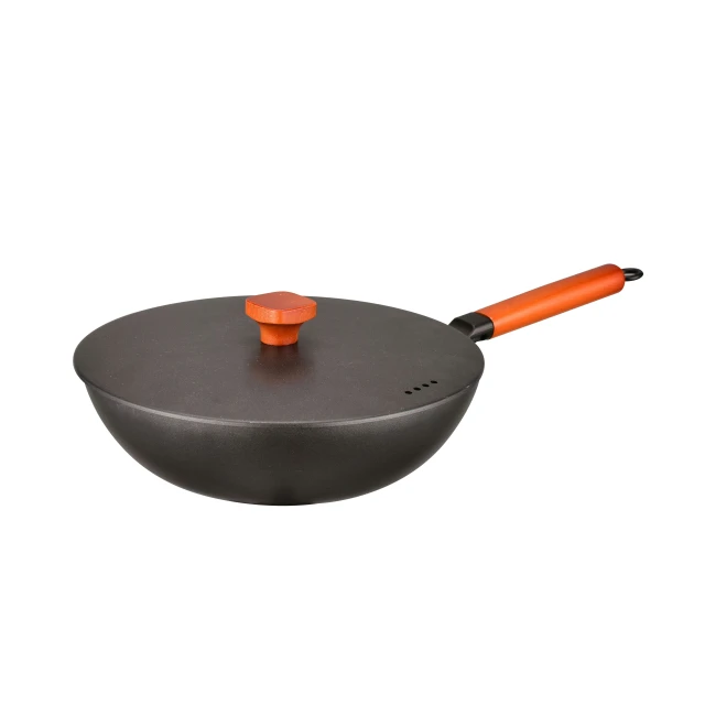 an orange spatula sits in a pan with a handle