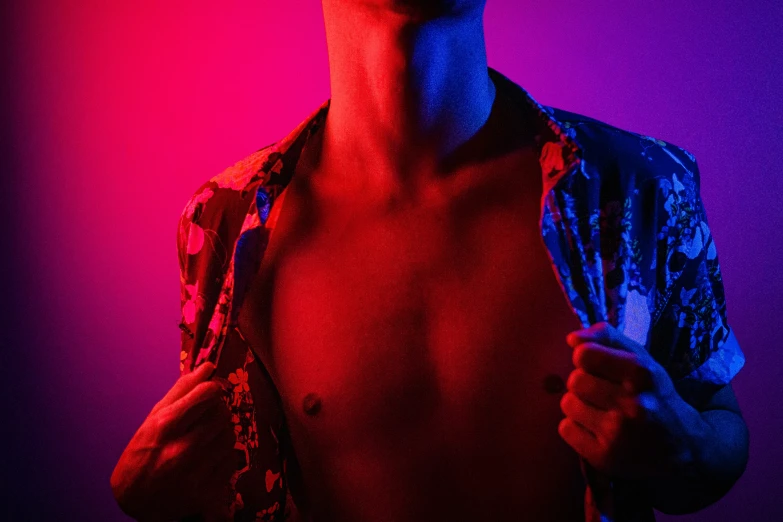 man with shirt open showing off red light from flash camera