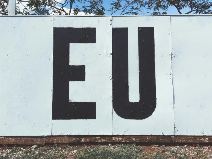 a white and black sign with the words eu on it