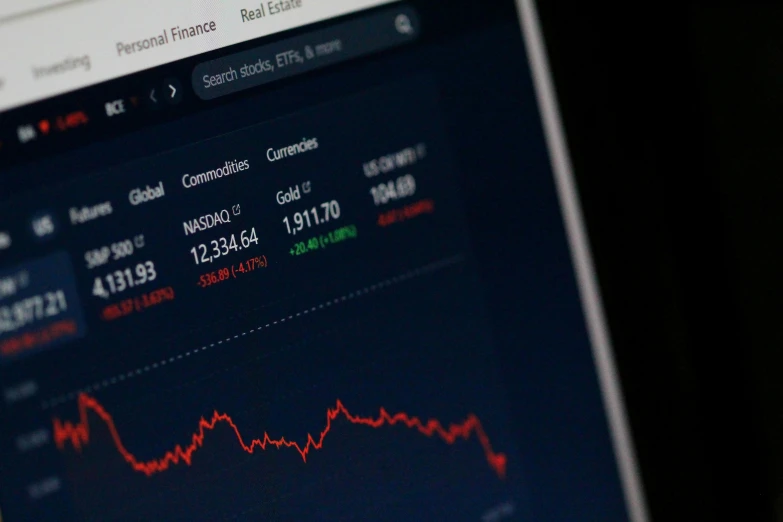 a stock market graph displayed on a laptop screen