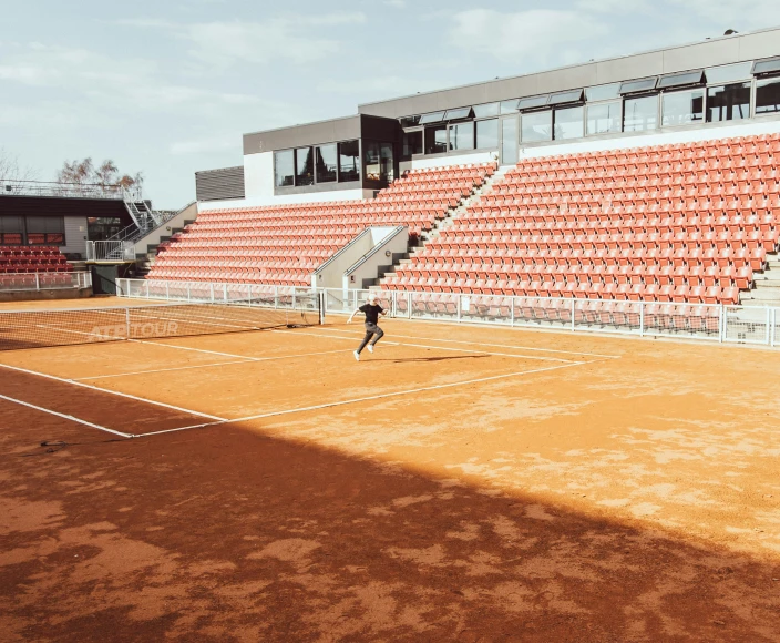 there is a man that is playing tennis on the court