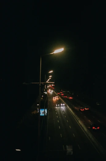 an empty highway at night time in the dark